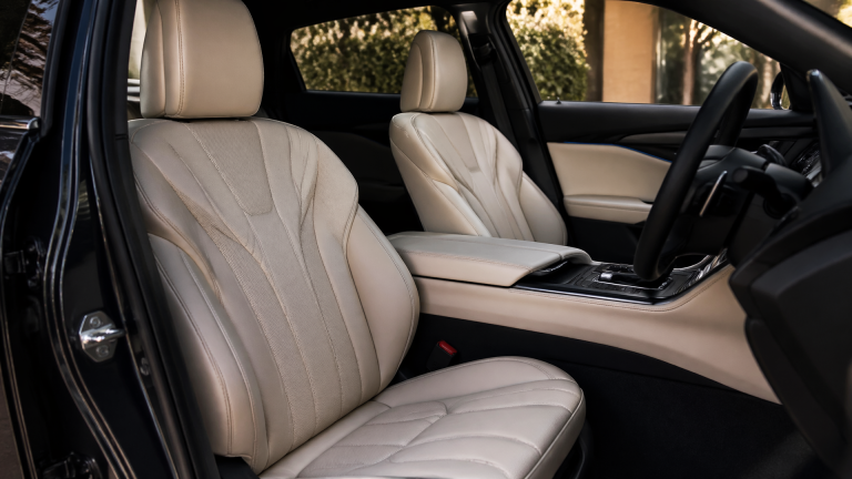 Interior view of a Lexus front seat showing perforated leather and massage seat controls on the door panel