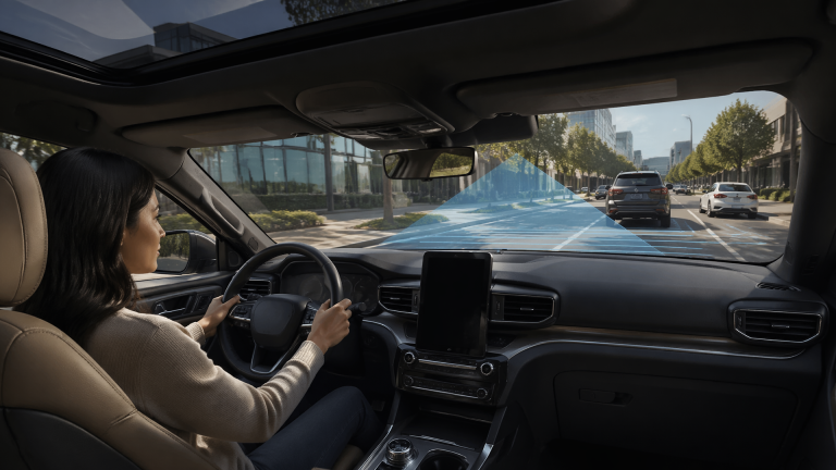 Front view of a Ford dashboard and windshield showing driver-assist lane markings and sensor indicators
